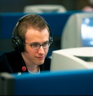 Student working on computer with headphones